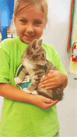 Girl adopting kitten