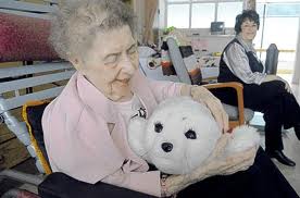 Woman holding robotic seal