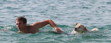Man Swimming With Dog
